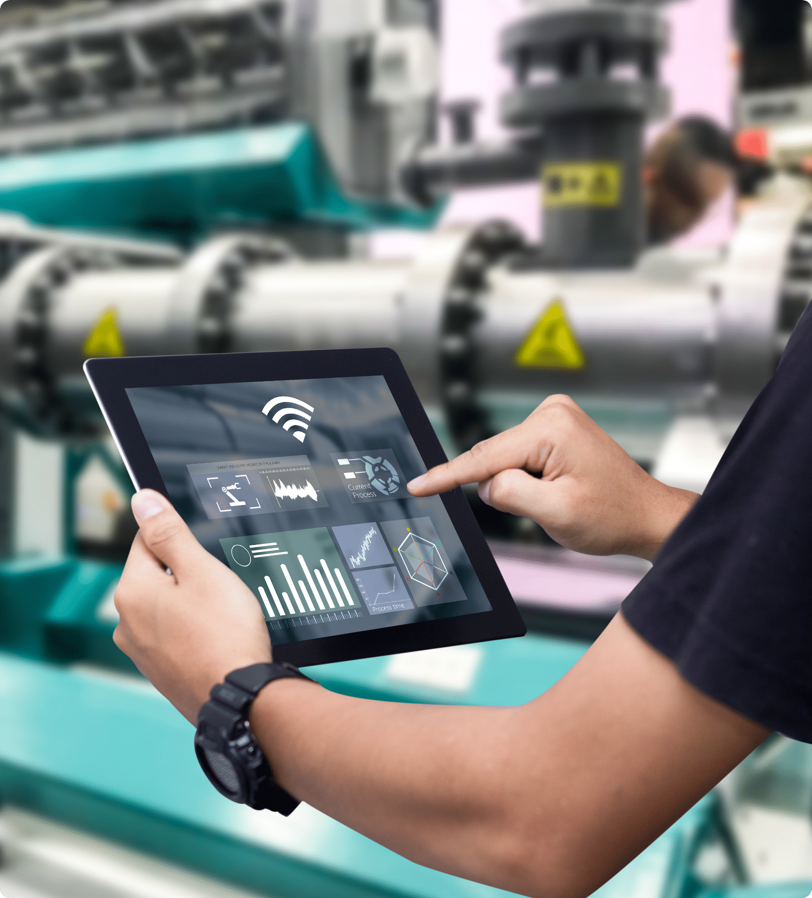 Someone using a tablet to check graphs and levels at an industrial job