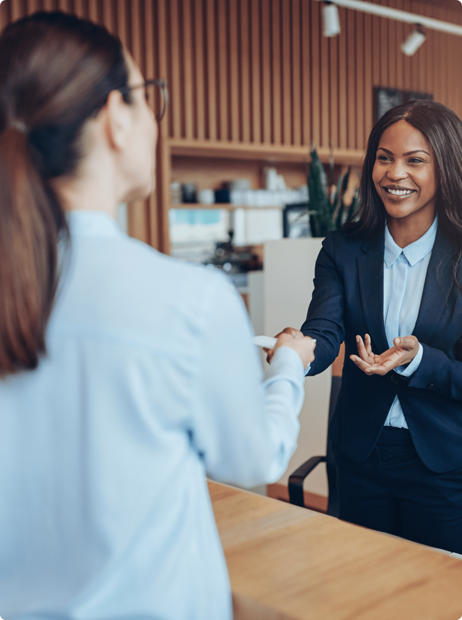 A woman recruiter shaking hands with a new hire