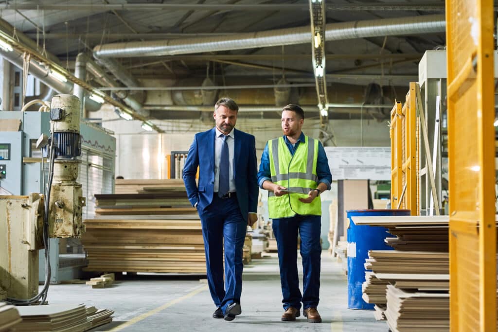 Mature Businessman Inspecting Modern Factory