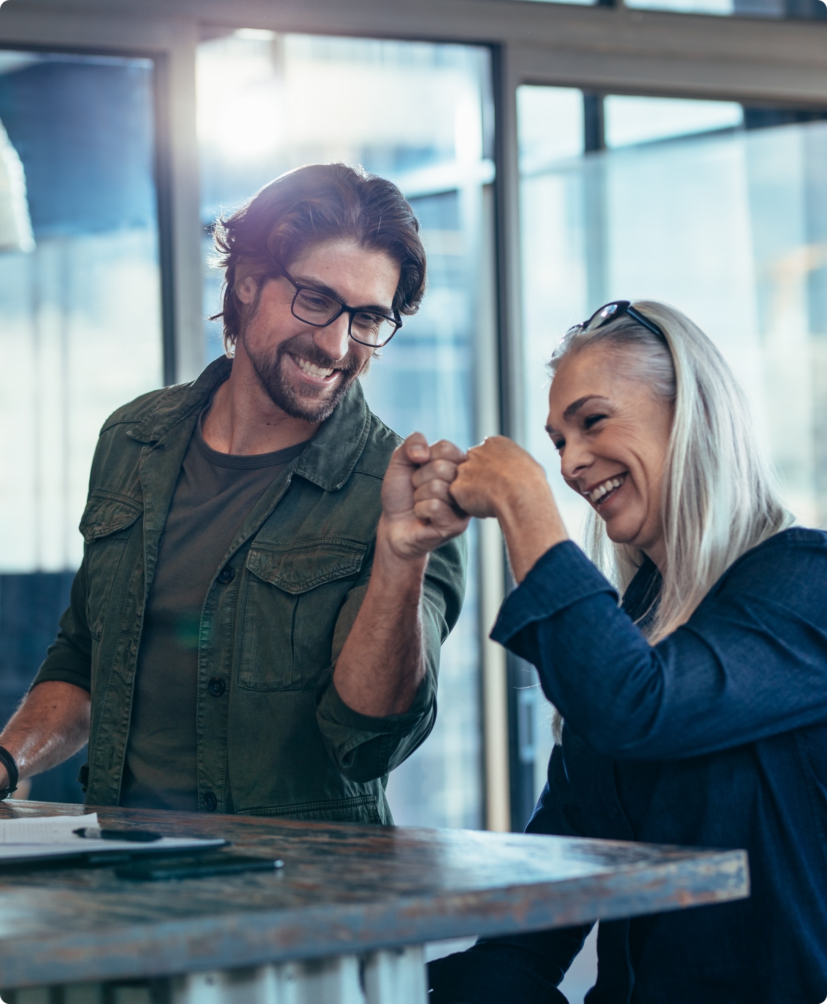 A woman and man fist bumping one another